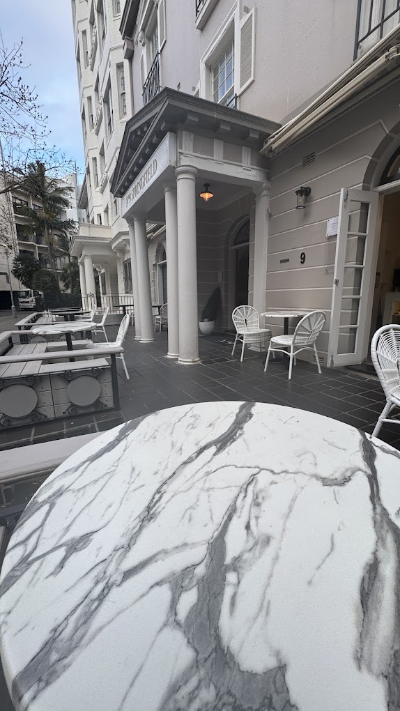 Marble tables and cane chairs on the Iki Cafe terrace in Potts Point